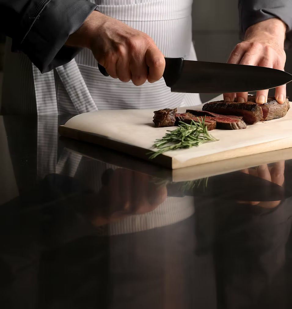 Chef cutting a steak