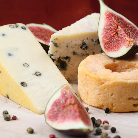 Assorted cheeses with figs on a marble board