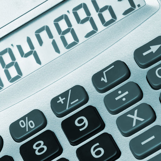 Close-up of a calculator with digital display and keypad