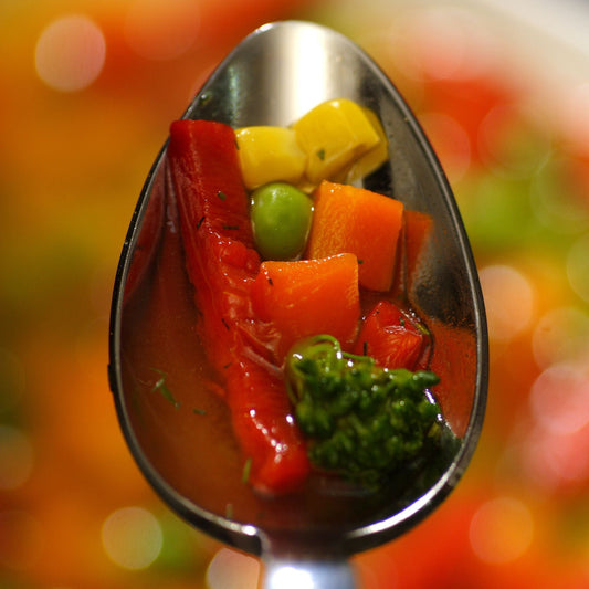 Spoonful of colorful vegetables in a blurred background
